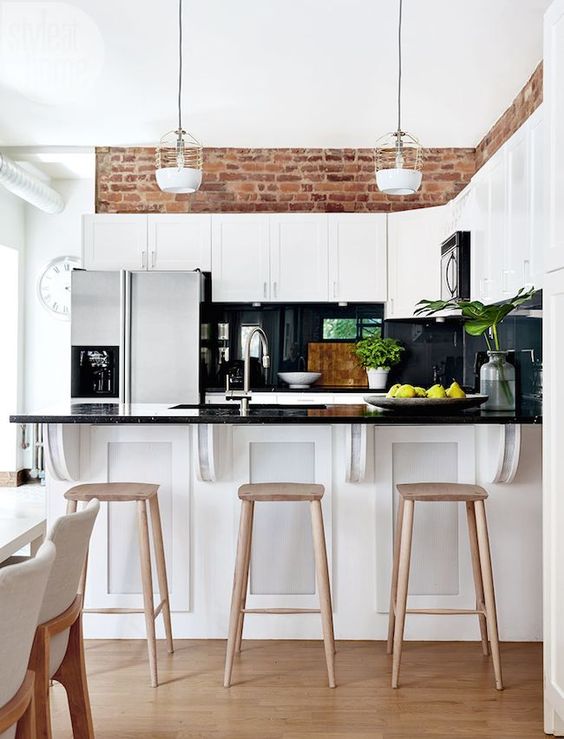 White Kitchen with Brick Above Cabinets